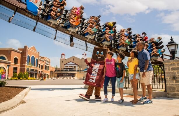 Hershey's Character and family watching Candymonium roller coaster at Hersheypark