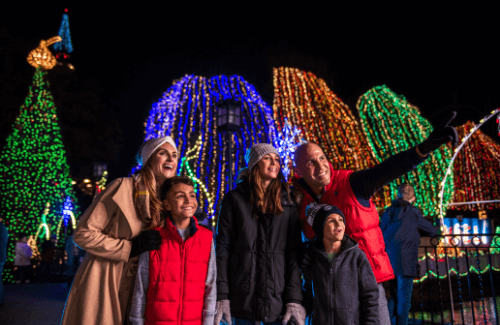 Family smiling together at Hersheypark Christmas Candylane