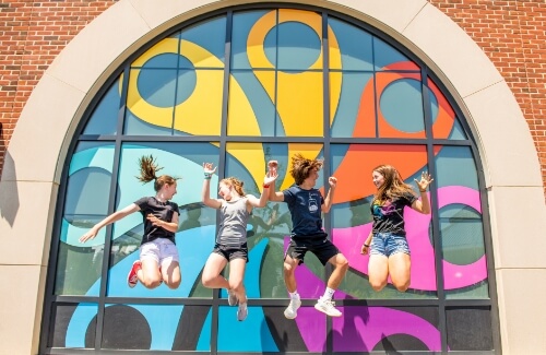 Kids jumping for joy in front of Hersheypark logo