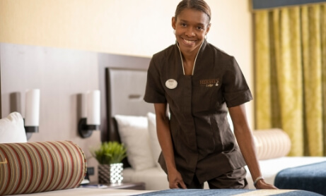 Resort Housekeeper making a bed