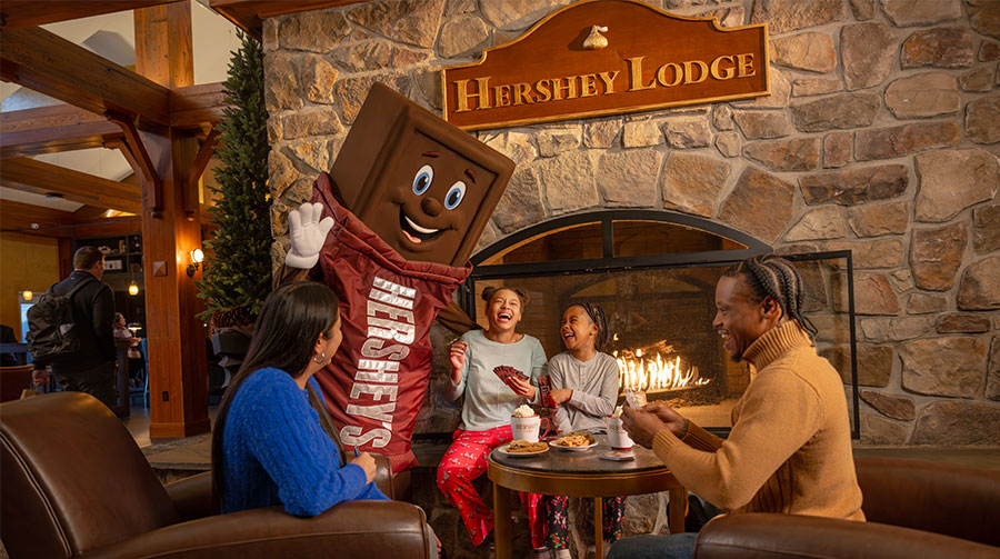 Family near fireplace at the Hershey Lodge.
