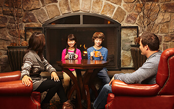 Family around fireplace at Hershey Lodge