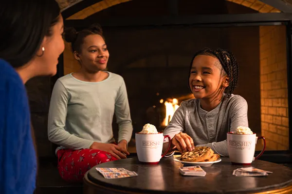 Mom and two kids with milk and cookies
